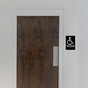 Accessible Bathroom With Black Braille Accessible Restroom Sign