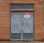 OSHA Danger High Voltage Sign on Metal Exterior Door