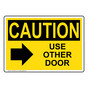OSHA CAUTION Use Other Door [Right Arrow] Sign With Symbol OCE-28784