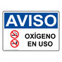 Spanish OSHA NOTICE Oxygen In Use Sign With Symbol - ONS-5139