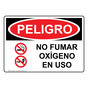 Spanish OSHA DANGER No Smoking Oxygen In Use Sign With Symbol - ODS-4871