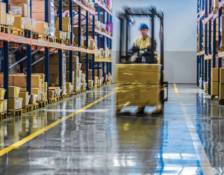 Floor tape defines travel aisles in a warehouse