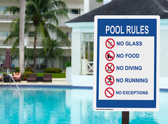 Displayed pool rules sign at poolside